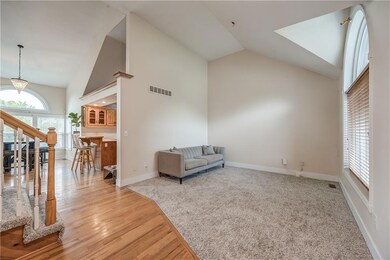 Living room or Formal Dining Room featuring a high vaulted ceiling and light carpet