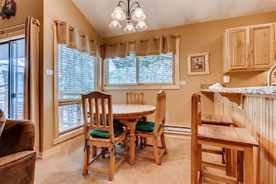 Dining space with an inviting chandelier, baseboar