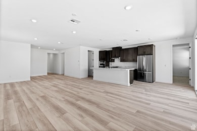 Unfurnished living room with light wood-style flooring and recessed lighting