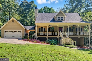 Front of the property featuring the large front porch and detached garage connected to the home by a covered breezeway.