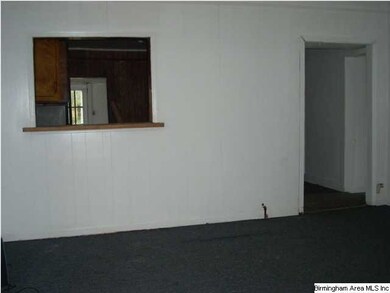 Large living room with a pass thru window to a hug