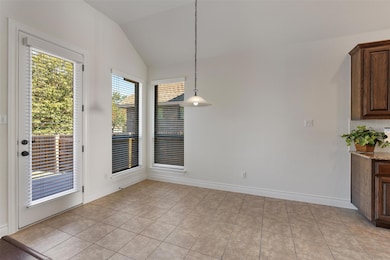 Unfurnished dining area featuring lofted ceiling 