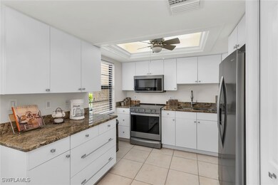 Kitchen featuring a tray ceiling, a sink, a ceilin