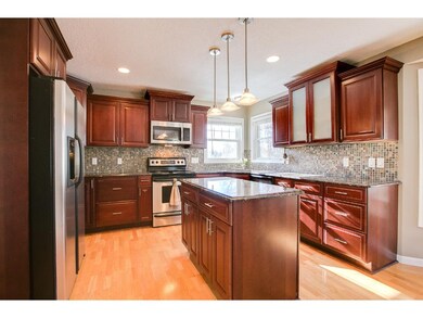 This kitchen boasts cherry cabinets, granite count