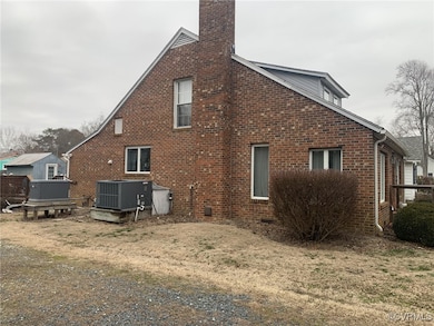 Rear view of property with a lawn, a chimney, craw