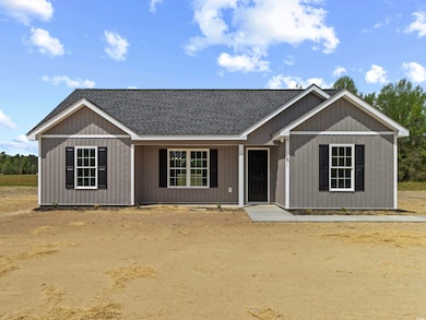 View of front facade featuring roof with shingles