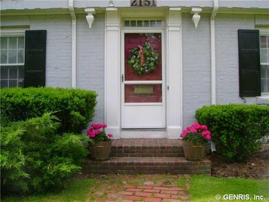 Exterior Front Spring wreath and bright geraniums 