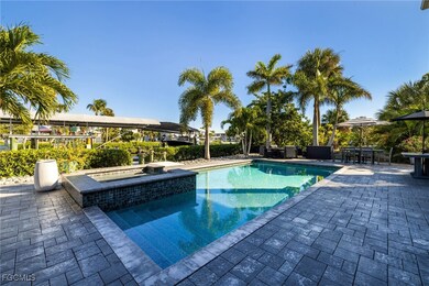 View of swimming pool with a patio, a pool with connected hot tub, and outdoor dining area
