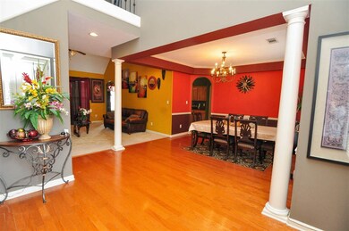 Beautiful columns and hardwood floors lead you int