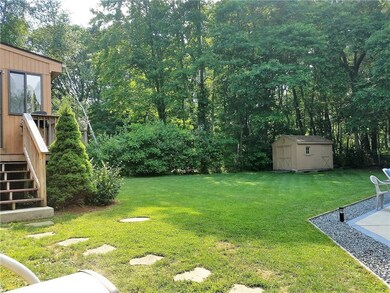 Back yard and shed. Stairs lead to the sun room