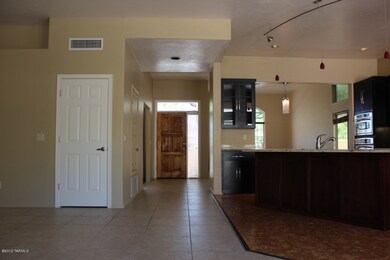 View of the entry and kitchen