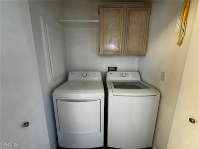 Laundry room featuring washing machine and clothes
