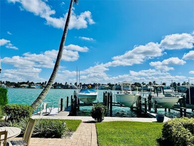 Dock with a water view, boat lift, and a yard