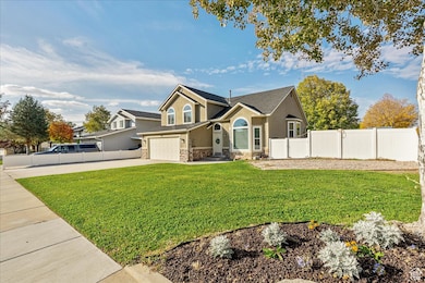 View of front of property featuring stone siding, driveway, and a garage