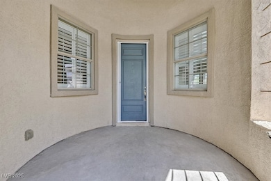 Property entrance with a patio and stucco siding