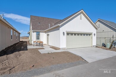 View of front of house with a garage, concrete driveway, roof with shingles, and board and batten siding