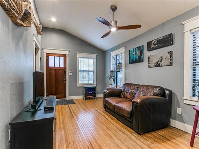 Living room with ceiling fan, lofted ceiling, and 
