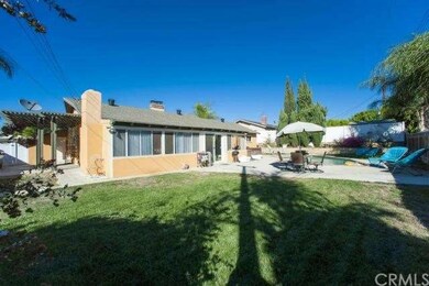 A large grassy area, patio and pool are here for y