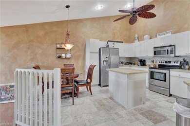 Kitchen with a towering ceiling, light countertops