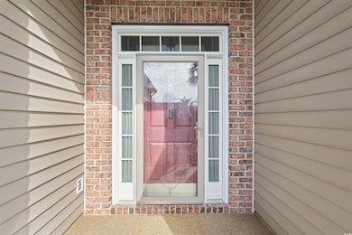 Entrance to property featuring brick siding