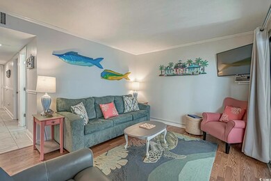 Living room featuring baseboard heating, ornamenta