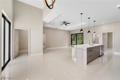 Kitchen featuring a sink, a ceiling fan, a raised