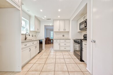 Light and bright kitchen. Ample cabinet space. Pantry to the right.