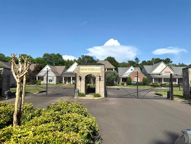 View of asphalt street featuring a gate, a residential view, and a gated entry