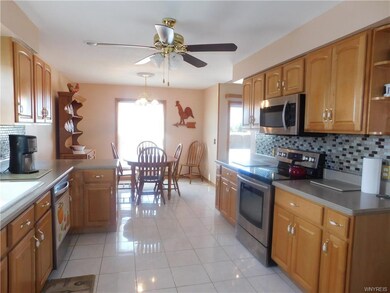 Eat in kitchen with ceramic flooring. Pantry and s