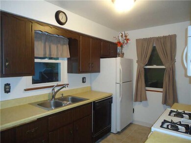 Kitchen. WOODEN CABINETRY/ REFRIGERATOR AND DISHWA