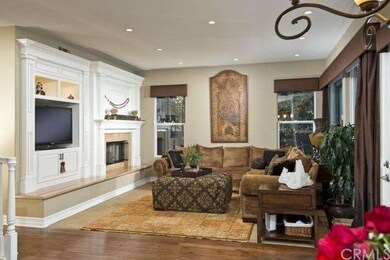 family room with custom built-ins and open to kitc