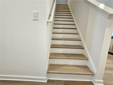 Staircase featuring wood finished floors and baseboards