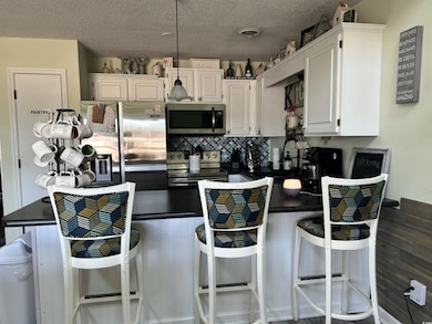 Kitchen featuring decorative backsplash, appliance