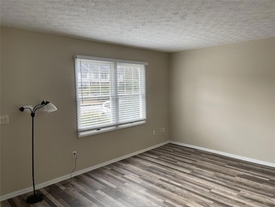 Empty room with wood finished floors, baseboards, 