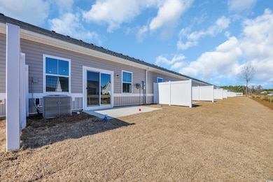 Rear view of house with a yard, a patio area, cool
