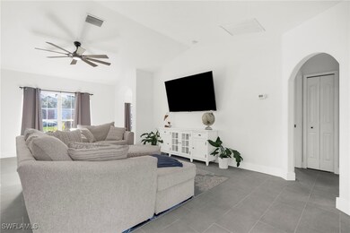 Living room featuring ceiling fan and lofted ceili