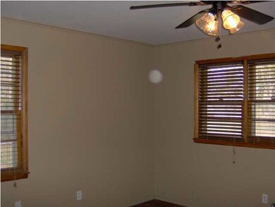 Bedroom with nice windows and hardwood floors