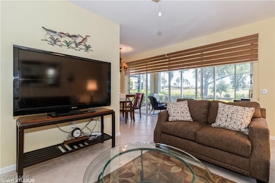 Living room featuring baseboards, an inviting chan