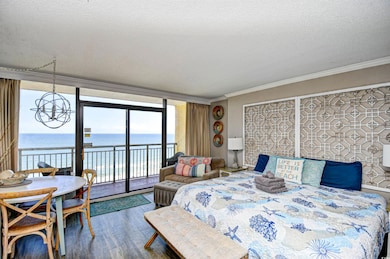 Bedroom with access to exterior, a water view, a t