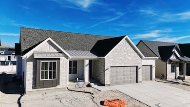 View of front of property featuring a standing seam roof, a metal roof, concrete driveway, a shingled roof, and a garage