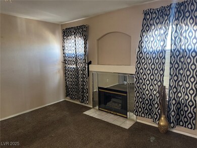 Unfurnished living room featuring carpet, a tile f