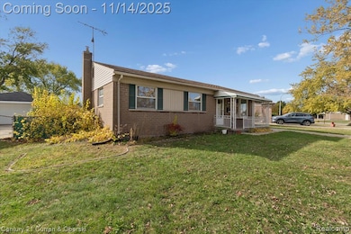 View of front facade with a chimney, brick siding, and a porch