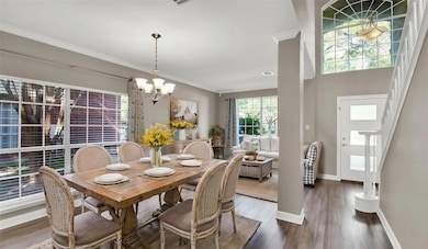 Dining space with a chandelier, crown molding, wo