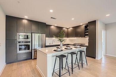 Kitchen featuring stainless steel appliances, ope