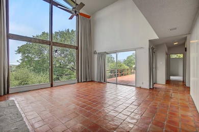 Unfurnished living room with high vaulted ceiling