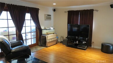 Living room with hardwood - like floors with sliding door out
