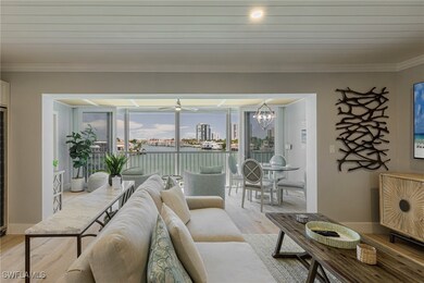Living area with light wood finished floors, crown molding, ceiling fan, and a chandelier