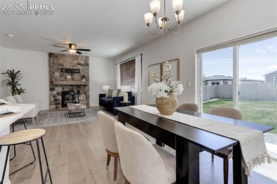 Dining area with ceiling fan, light wood-type floo