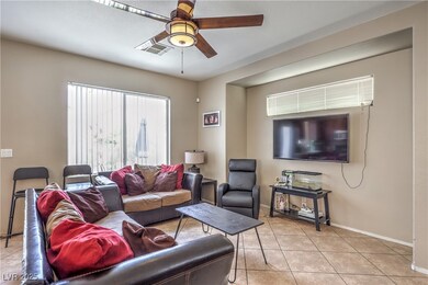 Living area featuring baseboards, a ceiling fan, l