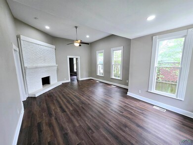 Unfurnished living room featuring dark wood-type f